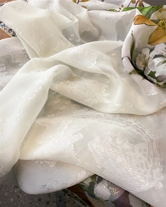 Macro detail of elegant white semi-transparent peony floral jacquard fabric for scarves