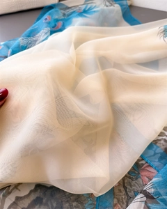 Macro view of semi-transparent lightweight chiffon scarf with intricate blue floral print
