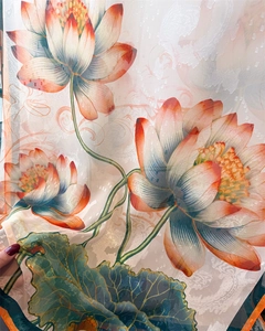 Close-up of lightweight silk scarf featuring elegant peony prints and translucent texture