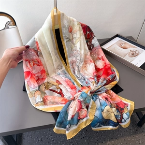 Lightweight floral silk scarf with colorful hand-painted patterns and golden edges
