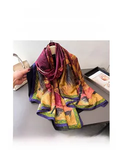 Detail of elegant silk scarf featuring vintage floral patterns in burgundy and yellow tones