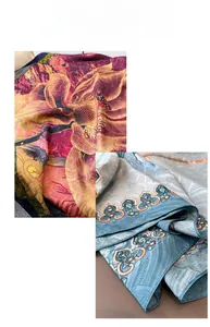 Detail of floral printed silk scarves in red and blue with elegant glossy texture