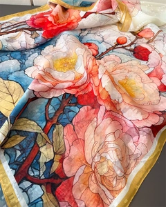 Macro shot of floral peony print silk shawl with delicate checkered texture and gold edges