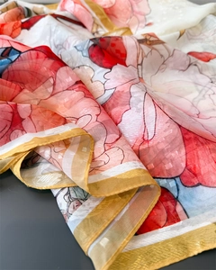 Detail of peony print silk scarf showing jacquard texture and elegant red floral pattern