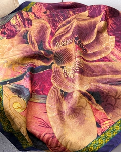 Detail of silk scarf featuring floral lotus prints and elegant deep purple border finish