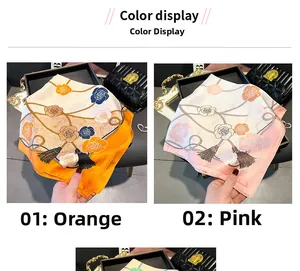 Detail of silk-like floral square scarves in orange and pink rose print colorways