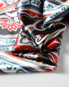 Close-up of retro paisley pattern on vibrant satin silk scarf with detailed textures