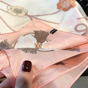 Close-up of pink and white rose print on soft satin silk scarf showing fine texture