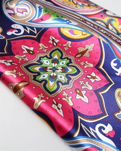 Detail of satin scarf with colorful Paisley patterns and silk-like smooth texture