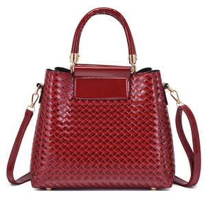 Large burgundy woven leather handbag with matching shoulder strap and gold hardware detail