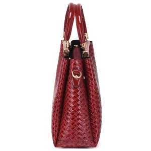 Large burgundy woven tote bag with glossy finish and top handles on white background