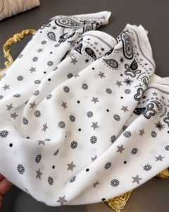 Detailed macro view of paisley and floral patterns on soft cotton-linen blend scarf