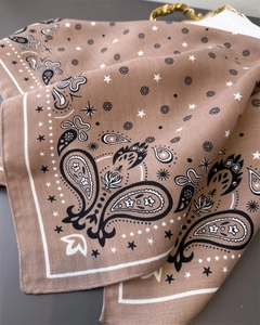 Close-up of brown paisley and star pattern on soft herringbone textured cotton scarf