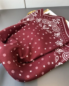 Detail of burgundy paisley scarf showing herringbone texture and white pattern