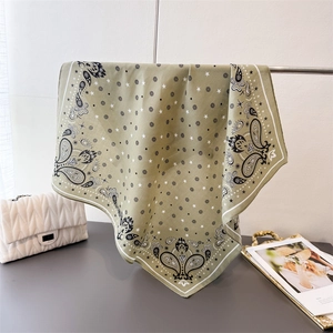 Detail of green paisley cotton linen square scarf with white star patterns