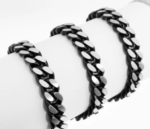 Macro shot of two-tone matte black and brushed silver stainless steel Cuban link chain