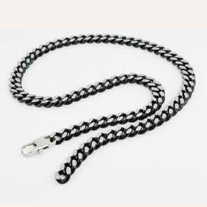 Detail of two-tone black and silver Cuban link chain with a sturdy lobster clasp