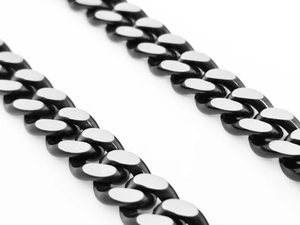 Macro shot of two-tone Cuban link chain with black coating and polished silver surface