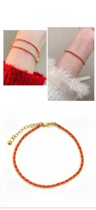 Detail eines roten geflochtenen Seilarmbands mit Goldperlen und verstellbarem Verschluss