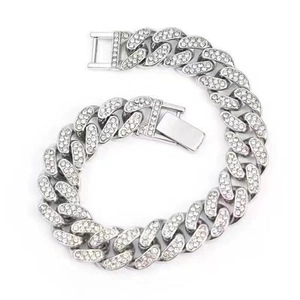 Close-up of 13mm silver iced-out Cuban link bracelet with double safety clasp and rhinestones