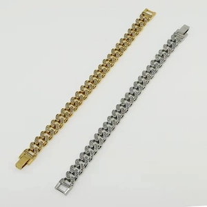 Detail of gold and silver Cuban link bracelets with iced-out micro-pave diamonds