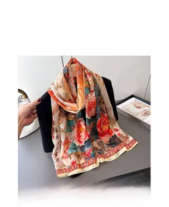 Detailed view of floral phoenix print silk scarf paired with a black tailored blazer