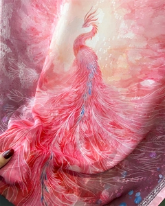 Detailed close-up of pink phoenix print on lightweight semi-transparent silk scarf fabric