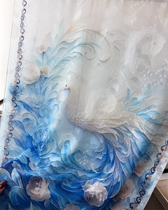 Detailed view of floral peacock embroidery on translucent purple silk scarf fabric