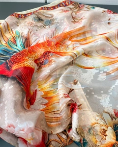 Detail of silk scarf showing intricate phoenix floral print and jacquard texture