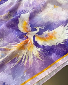 Macro shot of purple silk scarf featuring phoenix print and jacquard texture