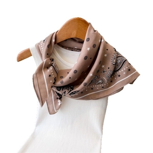 Mocha paisley silk scarf with star and dot patterns on a white knitted tank top