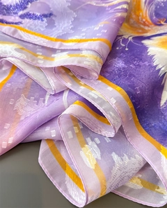 Detail of purple floral silk scarf with jacquard texture and rolled hem edge