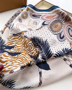 Detailed view of silky fashion scarf with animal print and paisley patterns