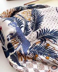 Detail of silk scarf with leopard and zebra prints showing smooth fabric texture