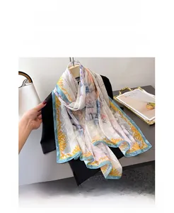 Detailed close-up of floral print and scrolls on elegant silk-feel long scarf