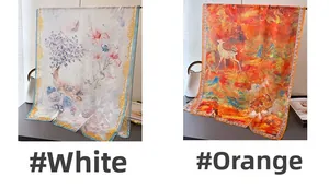 Artistic deer print long scarves in white and orange displayed with minimalist decor