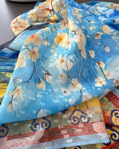 Detailed view of lightweight sky blue silk scarf with delicate floral prints and patterns