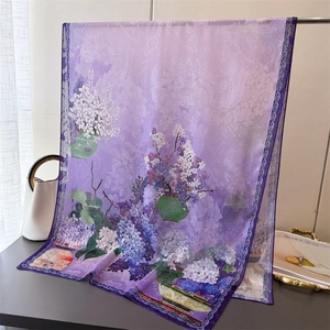 Close-up of floral print scarf with purple lilac and green floral patterns