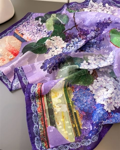 Detail of sheer purple chiffon scarf showing intricate floral patterns and fine hem stitching