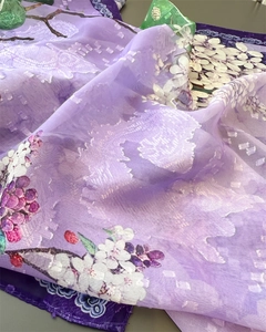 Detailed macro view of purple silk scarf with floral print and embroidered edges