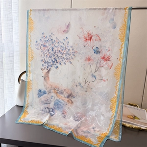 Macro view of lightweight floral deer print scarf with delicate sheer texture and yellow border