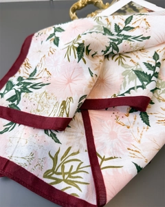 Detailed view of daisy pattern scarf with twill texture and burgundy hem borders