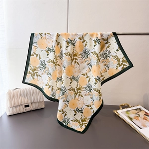 Lightweight square floral scarf featuring yellow daisy prints and a deep green border