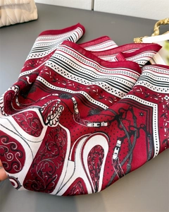 Detailed close-up of herringbone silk scarf featuring equestrian motifs and baroque patterns