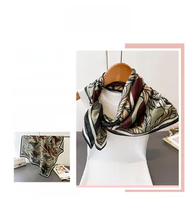 Detail of elegant leaf pattern square scarf with retro vine print and cotton-linen texture