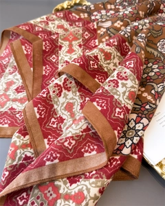 Close-up of bohemian leaf pattern cotton-linen scarf with vintage red and brown prints
