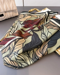 Close-up of silk scarf showing detailed herringbone texture and vintage leaf pattern
