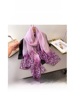 Close-up of purple gradient floral silk scarf with delicate white flower print detail