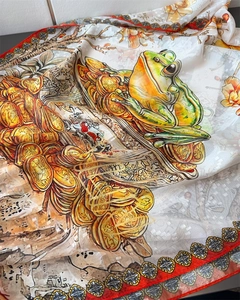 Detailed macro of a silk scarf featuring a lucky green frog print on a grid pattern