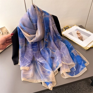 Blue and purple gradient floral print long scarf draped over a black suit blazer